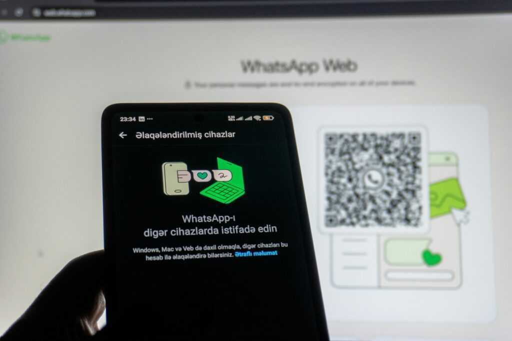 Phone scanning whatsapp web qr code on screen